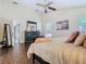 Bedroom features ceiling fan, hardwood floors, and a comfortable queen-sized bed at 216 Springside Rd, Longwood, FL 32779