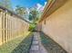 Side yard with a stepping stone pathway and lush greenery, creating a serene walkway at 216 Springside Rd, Longwood, FL 32779