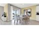 Dining room featuring a white dining table, stylish chairs, and sliding glass doors to the backyard at 2801 Jamaica Way, Haines City, FL 33844