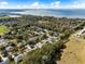 Beautiful neighborhood aerial featuring lush trees surrounding well-maintained homes and a distant water view at 2856 Park Meadow Dr, Apopka, FL 32703