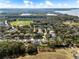 Picturesque aerial image of a neighborhood with mature trees and landscaping, as well as a nearby body of water at 2856 Park Meadow Dr, Apopka, FL 32703