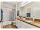 Bathroom with a granite countertop vanity, framed mirror, and a bathtub-shower combination at 2856 Park Meadow Dr, Apopka, FL 32703