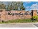 Brick entrance sign for the Magnolia Park Estates community, surrounded by well-maintained landscaping and greenery at 2856 Park Meadow Dr, Apopka, FL 32703