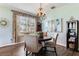 Cozy dining area with elegant chandelier, round table, and sophisticated wall art at 2856 Park Meadow Dr, Apopka, FL 32703