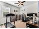 Functional home office with treadmill, media shelves, and desk, lit by a bright window at 2856 Park Meadow Dr, Apopka, FL 32703