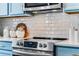 Close-up of the stainless steel range and white subway tile backsplash in a modern kitchen at 2856 Park Meadow Dr, Apopka, FL 32703