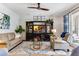 Cozy living room featuring comfortable sofas, a ceiling fan, and a stylish entertainment center at 2856 Park Meadow Dr, Apopka, FL 32703