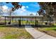 Covered community picnic area featuring multiple picnic tables, trash cans, and green space for outdoor gatherings at 2856 Park Meadow Dr, Apopka, FL 32703