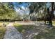 Community playground with swings and slides surrounded by mature trees and convenient benches for relaxing at 2856 Park Meadow Dr, Apopka, FL 32703