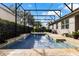 A serene screened-in pool boasts a tanning ledge and waterfall feature, perfect for relaxation and enjoyment at 2856 Park Meadow Dr, Apopka, FL 32703