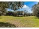 A verdant lawn with mature trees creates a peaceful and inviting outdoor space for recreation and enjoyment at 2856 Park Meadow Dr, Apopka, FL 32703