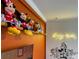 Adorable room featuring playful Disney decorations and plush cartoon character dolls on shelving at 2904 Penelope Loop, Kissimmee, FL 34746