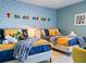 Bedroom with colorful 'Toy Story' themed decorations and two comfortable twin beds at 2904 Penelope Loop, Kissimmee, FL 34746