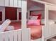 Unique bunk bed with twin beds, custom white frame, and decorative princess themed pillow accents at 2904 Penelope Loop, Kissimmee, FL 34746