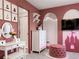 Pink themed bedroom includes vanity and a bathroom with stand up shower at 2904 Penelope Loop, Kissimmee, FL 34746