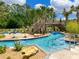 Resort-style lazy river with bridge, tropical landscaping, and clear blue water for a relaxing community experience at 2904 Penelope Loop, Kissimmee, FL 34746