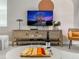 Close-up of living room showing TV, wine, cheese board, and comfortable seating area at 2904 Penelope Loop, Kissimmee, FL 34746