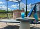 Outdoor bar and lounge area in screened in patio overlooking the lake, perfect for relaxing at 2904 Penelope Loop, Kissimmee, FL 34746