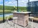 Outdoor bar with stools and blue beverages with a view to the pool at 2904 Penelope Loop, Kissimmee, FL 34746