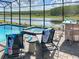 Inviting screened-in pool area with comfortable lounge chairs, hot tub, and outdoor bar at 2904 Penelope Loop, Kissimmee, FL 34746