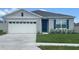 Charming single-story home features a gray exterior, attached two car garage, and well-manicured lawn at 2926 Reggae Pl, Haines City, FL 33844