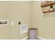 Compact laundry room with neutral yellow walls and shelving, ready for appliances at 2926 Reggae Pl, Haines City, FL 33844