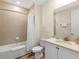 Bathroom features a bathtub and shower combo and a vanity with a sink at 2927 Castaway Ln, Kissimmee, FL 34747