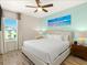 Bright bedroom features a ceiling fan, stylish decor and natural light from the large window at 2927 Castaway Ln, Kissimmee, FL 34747