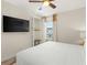 A TV is mounted above the bed with a closet next to the window at 2927 Castaway Ln, Kissimmee, FL 34747