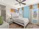 Inviting bedroom with a large bed, turquoise accent wall and two bright windows at 2927 Castaway Ln, Kissimmee, FL 34747