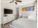 A TV is mounted above a dresser next to the bed with an ensuite door at 2927 Castaway Ln, Kissimmee, FL 34747