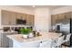 Bright kitchen featuring quartz countertops, gray cabinetry, and modern stainless-steel appliances at 3587 Davenport Creek Ct, Kissimmee, FL 34746