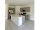 Bright kitchen with gray cabinetry, a center island, and modern stainless steel appliances at 3587 Davenport Creek Ct, Kissimmee, FL 34746