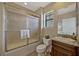 Bathroom featuring a glass-enclosed shower, a granite-topped vanity, and a window for natural light at 3909 Messina Dr, Lake Mary, FL 32746