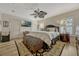 Cozy bedroom features a ceiling fan, two windows with blinds, and an area rug at 3909 Messina Dr, Lake Mary, FL 32746