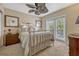 Bright bedroom featuring neutral carpet, silver bed frame, and French doors to a balcony at 3909 Messina Dr, Lake Mary, FL 32746