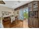 Cozy dining area featuring hardwood floors, custom wine rack, and sliding glass doors to balcony at 3909 Messina Dr, Lake Mary, FL 32746