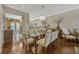 Dining room with hardwood floors and modern chandelier adjacent to the kitchen at 3909 Messina Dr, Lake Mary, FL 32746