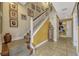 Inviting foyer with staircase, neutral decor, and tile flooring flows seamlessly into the rest of the home at 3909 Messina Dr, Lake Mary, FL 32746