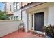 Charming front entrance featuring a brick-paved porch, black door, and manicured landscaping at 3909 Messina Dr, Lake Mary, FL 32746