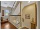 Second-story hallway with hardwood floors, white banister, and stairway at 3909 Messina Dr, Lake Mary, FL 32746