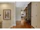 Bright hallway featuring hardwood floors, neutral paint, decorative screen, and access to other rooms at 3909 Messina Dr, Lake Mary, FL 32746