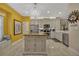 Bright kitchen featuring an island, stainless steel appliances, and sunny yellow walls at 3909 Messina Dr, Lake Mary, FL 32746