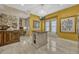 Sunlit kitchen featuring an island, yellow walls, and window seating at 3909 Messina Dr, Lake Mary, FL 32746