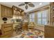 Cozy home office with custom wooden cabinets, a built-in desk, and natural light from shuttered windows at 3909 Messina Dr, Lake Mary, FL 32746