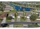 Aerial view of homes in a community surrounding a lake with a fountain, showcasing the desirable neighborhood setting at 4057 Sunny Day Way, Kissimmee, FL 34744