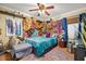 Inviting bedroom with unique colorful draping, stylish decor, and a ceiling fan at 4057 Sunny Day Way, Kissimmee, FL 34744