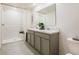 Bright bathroom featuring a double sink vanity and walk-in shower with white subway tile at 41 Redwood Ct, Kissimmee, FL 34759