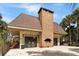 Pool house with a brick chimney, tile roof, and exterior staircase at 4109 Dijon Dr # 4109H, Orlando, FL 32808