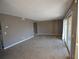 Bright living room with carpet, fresh paint and sliding glass door at 4109 Dijon Dr # 4109H, Orlando, FL 32808